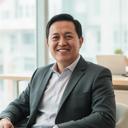 Singapore business owner in a tailored jacket seated in a bright office